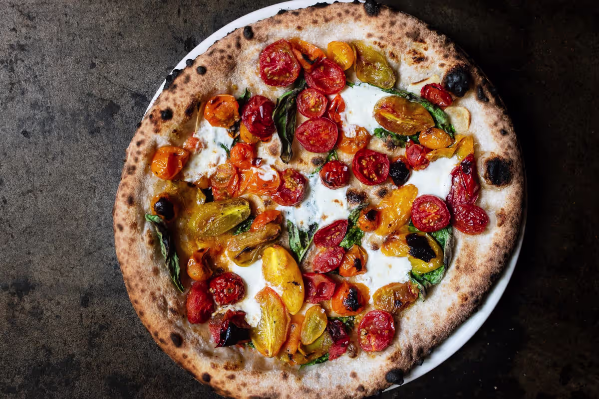 Louie Restaurant STL signature dishes  Wood-Fired Pizzas (e.g., Margherita, Spicy Sausage), various handmade pasta dishes, Roasted Chicken, Pork Chop Milanese, seasonal vegetable preparations.